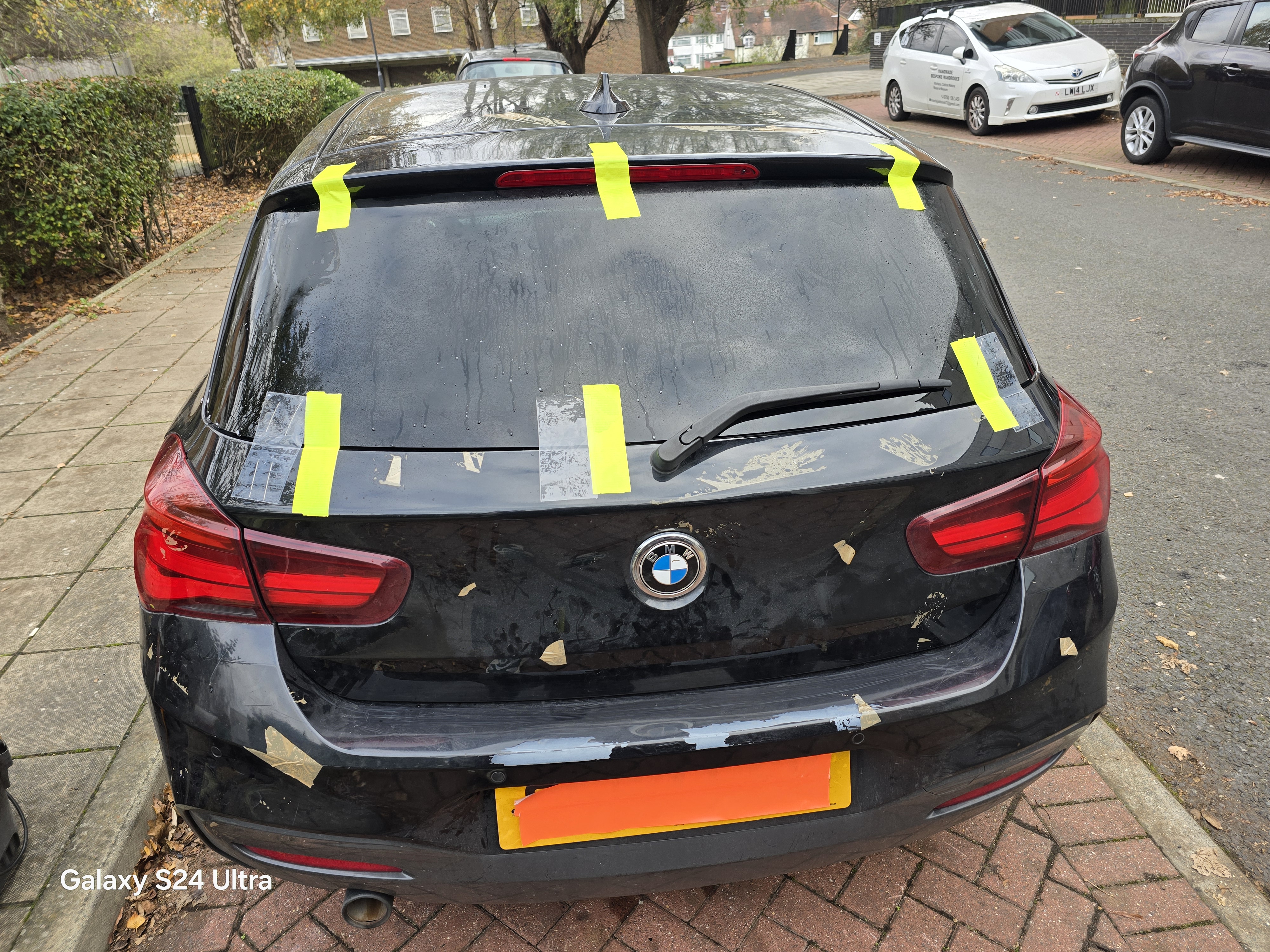 BMW 1 Series rear windscreen replacement in Walthamstow — glass taped and ready for removal by JJ Windscreens