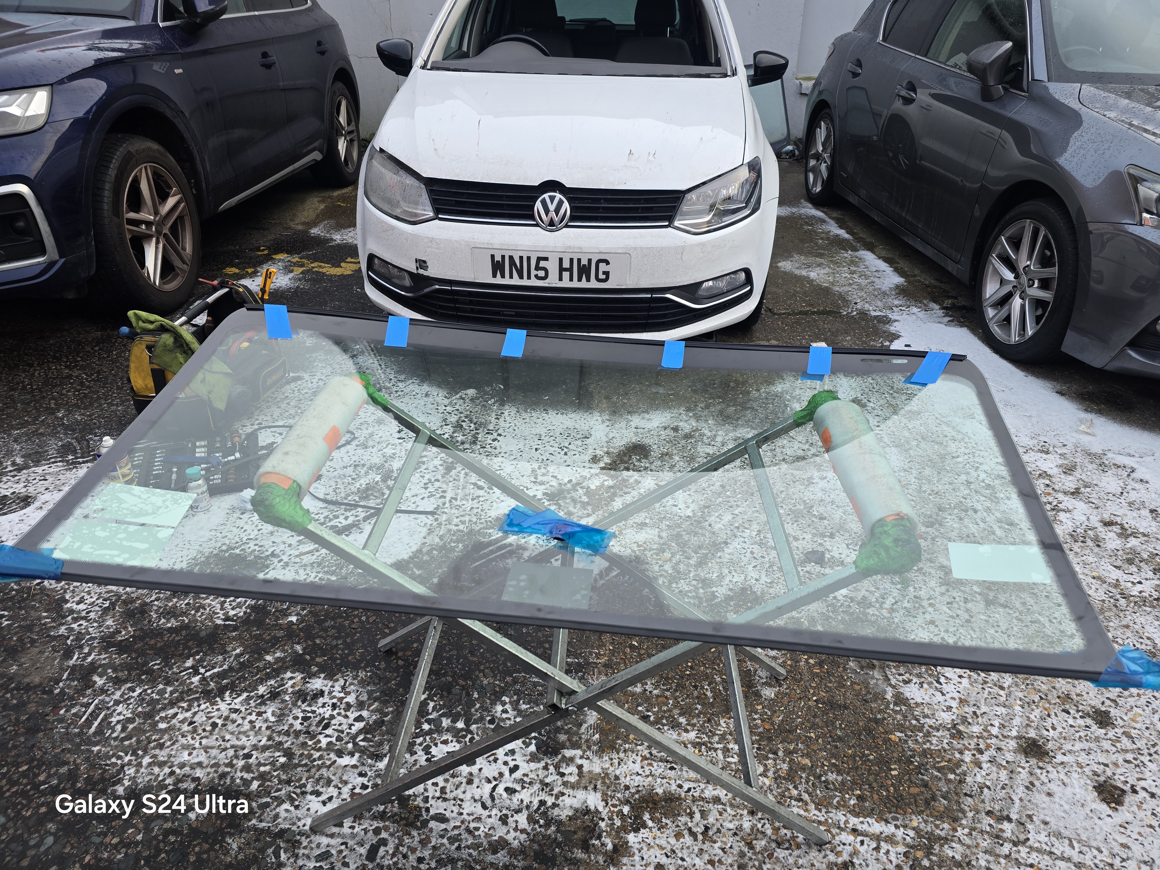 VW Polo windscreen replacement in Walthamstow E17 — new glass prepared on stand by JJ Windscreens mobile technician