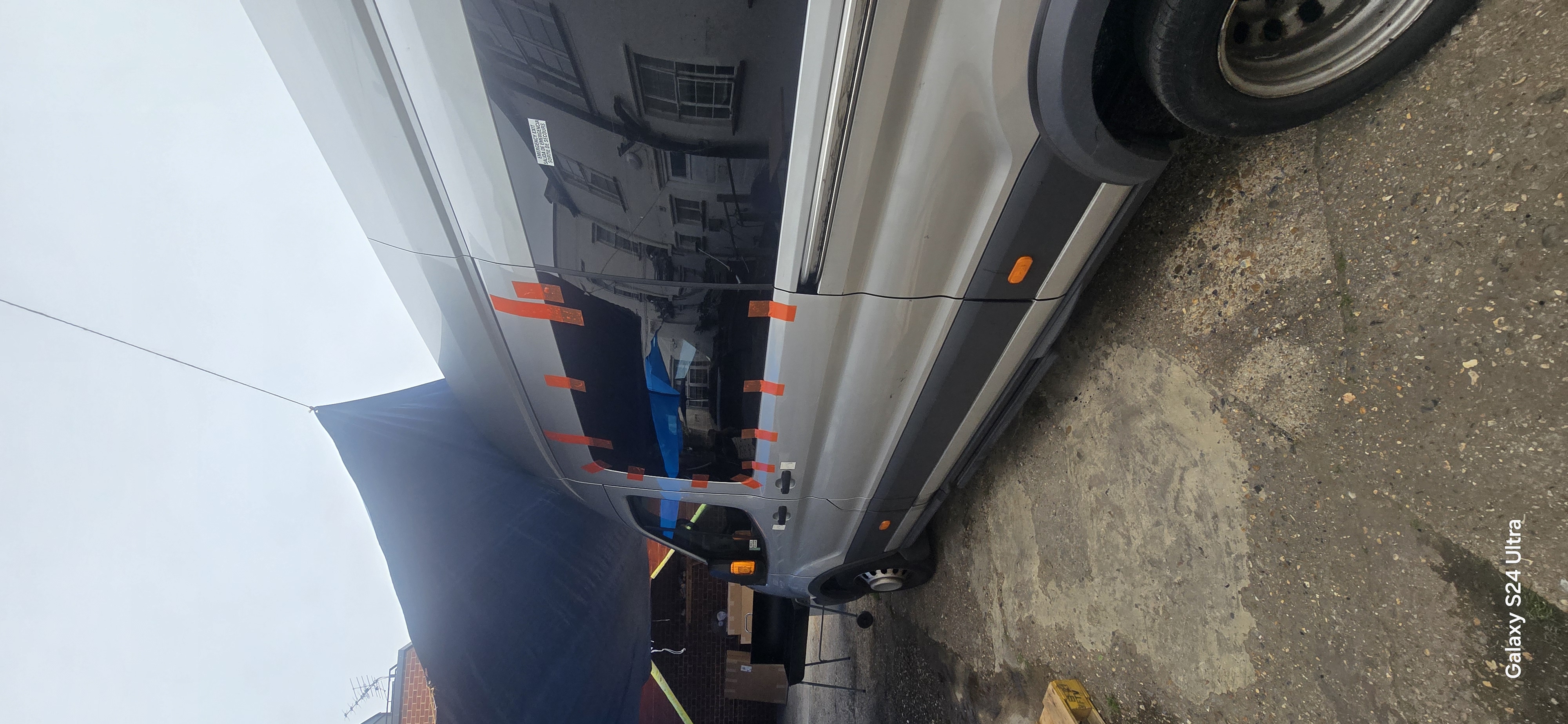 JJ Windscreens technician fitting a van side door glass